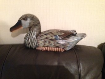 Antique A 20th century carved 33cm by 10cm wooden painted decoy duck with brown glass eyes.