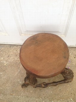 Antique A skilfully crafted and quite unusual early 20th century solid round topped wooden stool with vine root legs.