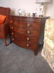 George III mahogany bowfront chest incorporating lead-lined wine cooler. c.1810