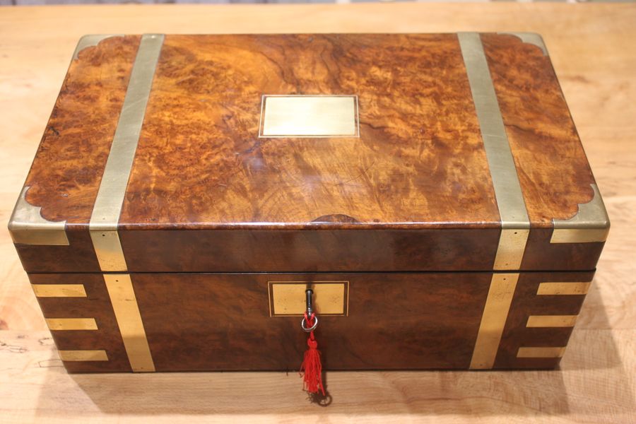 A quality walnut writing slope with stationery compartments, secret drawers etc.