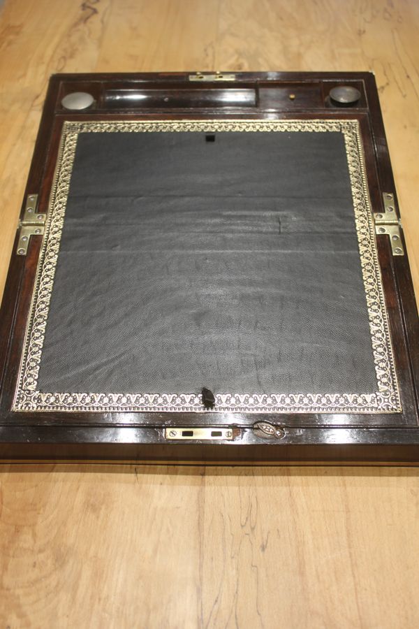 Antique A Brass Bound Writing Slope with a fitted interior to include Inkwells, Pen...	