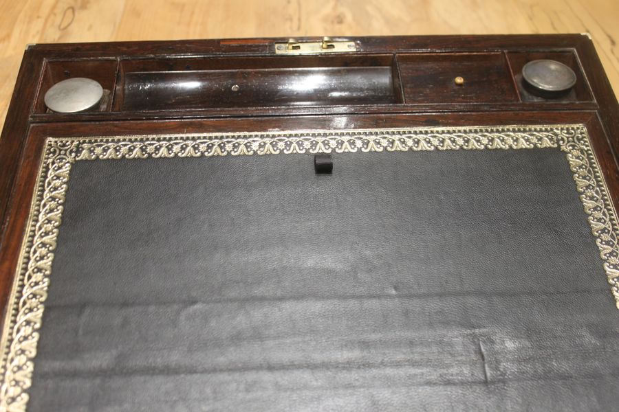 Antique A Brass Bound Writing Slope with a fitted interior to include Inkwells, Pen...	