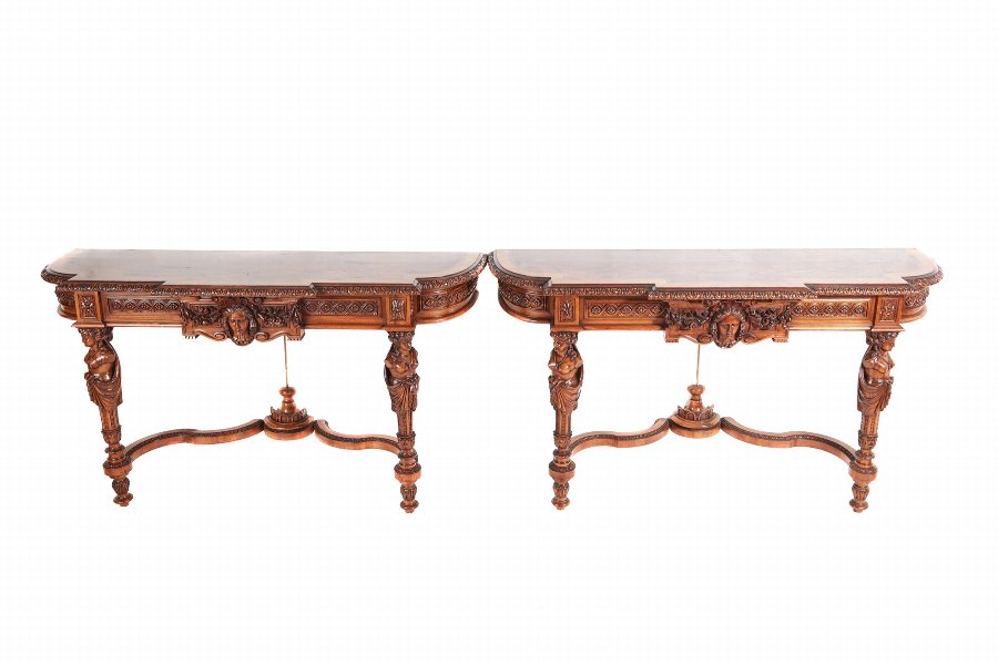 A FINE AND RARE PAIR OF FRENCH CARVED WALNUT CONSOLE TABLES