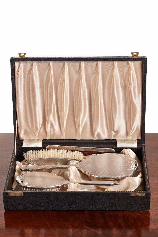 A CASED SILVER FOUR - PIECE BRUSH SET