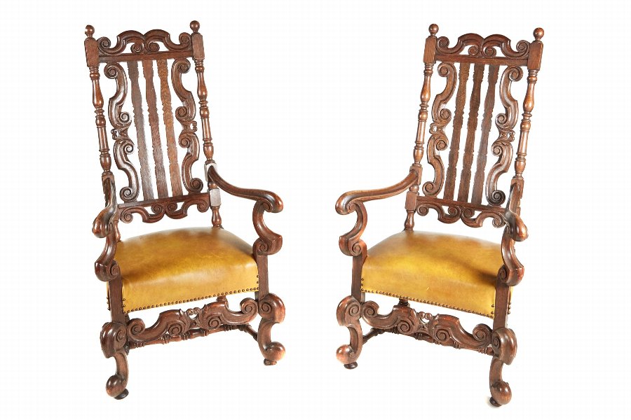 A large pair of Charles II style oak armchairs