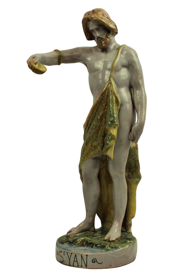 A SPANISH MAJOLICA STATUE OF ST JOHN THE BAPTIST