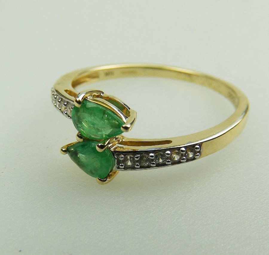 Vintage Jewellery a 10ct gold, emerald and white topaz Crossover Ring Boxed