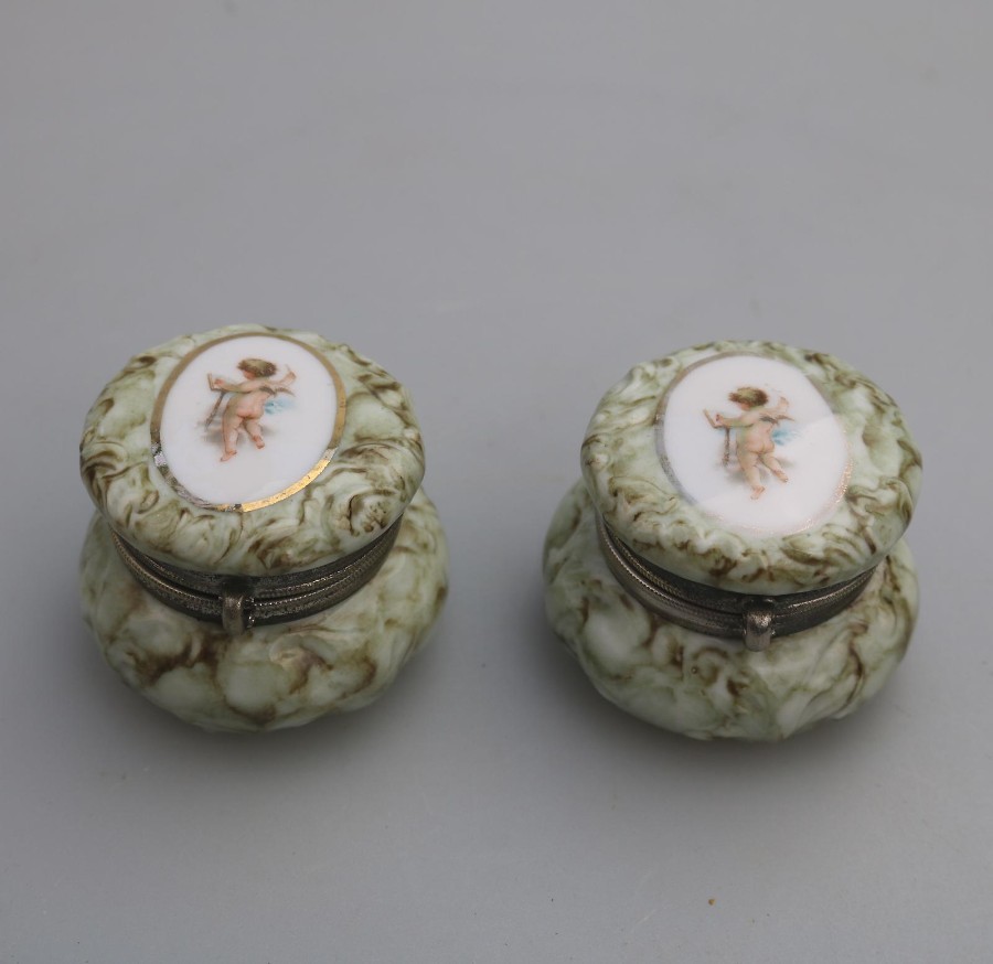 Antique Porcelain a pair of Continental Cherub lidded Jars Boxes C.19thC