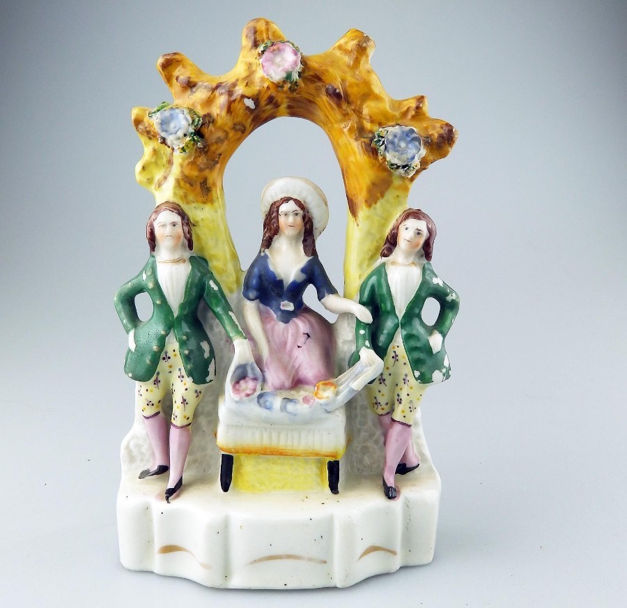 An attractive Staffordshire pottery Group of a girl with her two suitors