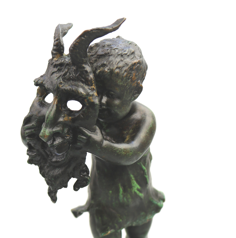 A very fine antique bronze sculpture of child with devil mask C.19thC