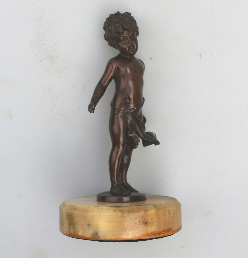A fine and very charming antique bronze sculpture of child & Fly C.19thC