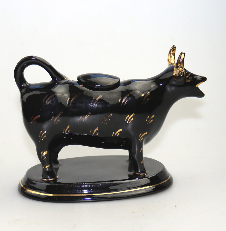 An antique Staffordshire Jackfield pottery novelty Cow Creamer C.19thC