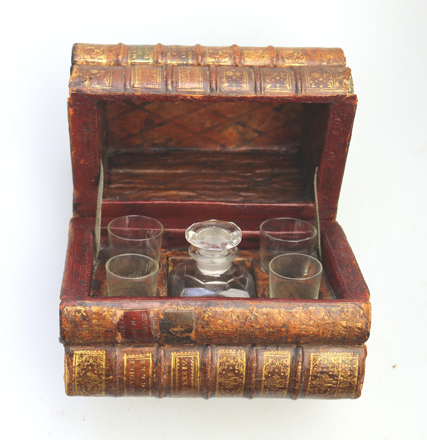 A scarce antique novelty Drinking Decanter Set contained in secret stack of books C.1890