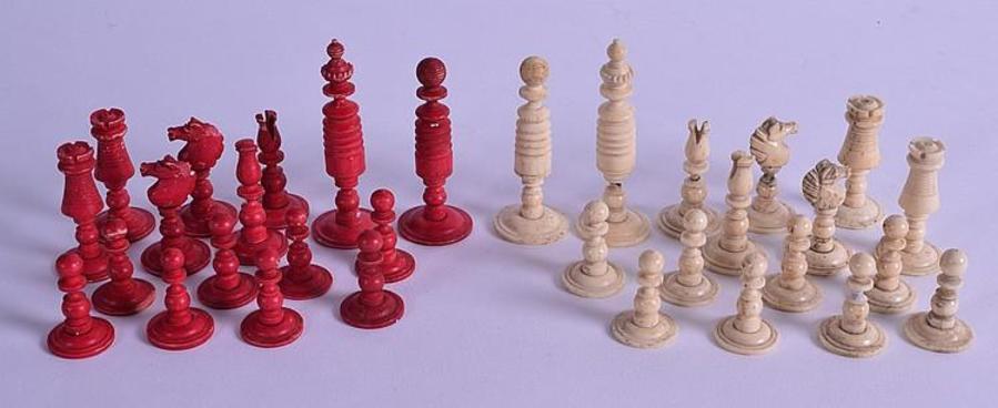 AN EARLY 19TH CENTURY CARVED AND STAINED BONE CHESS SET