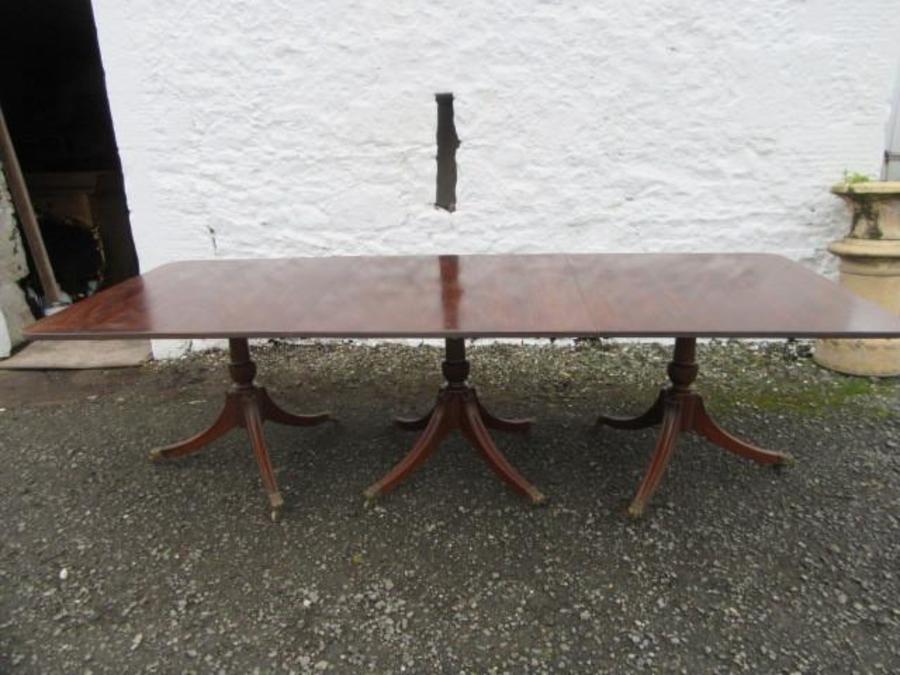 An Edwardian mahogany three pedistal dining table