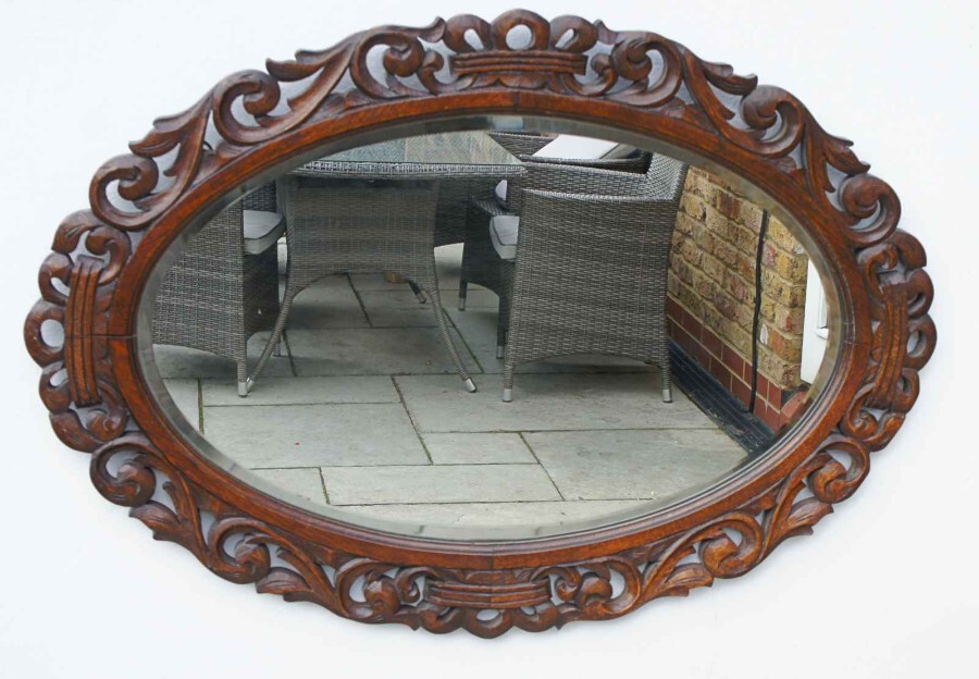 Early 20th Carolean style carved Oak overmantle mirror
