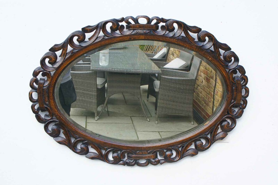 Early 20th Carolean style carved Oak overmantle mirror