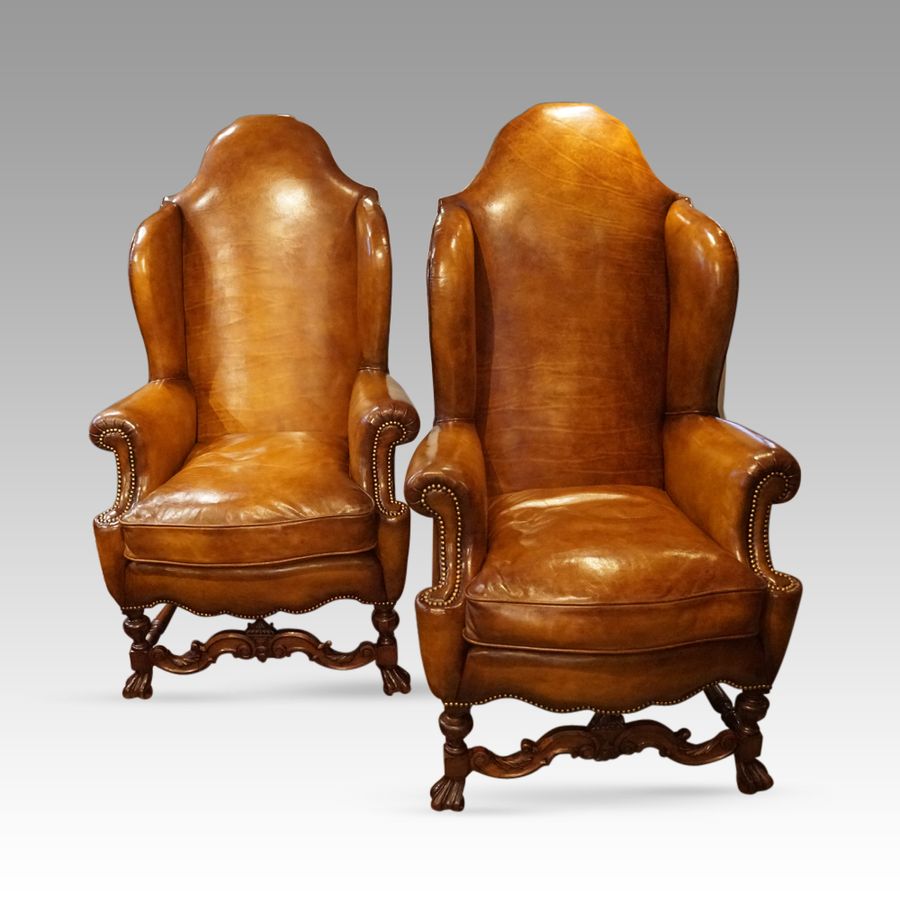 Antique Pair of large leather wing back chairs