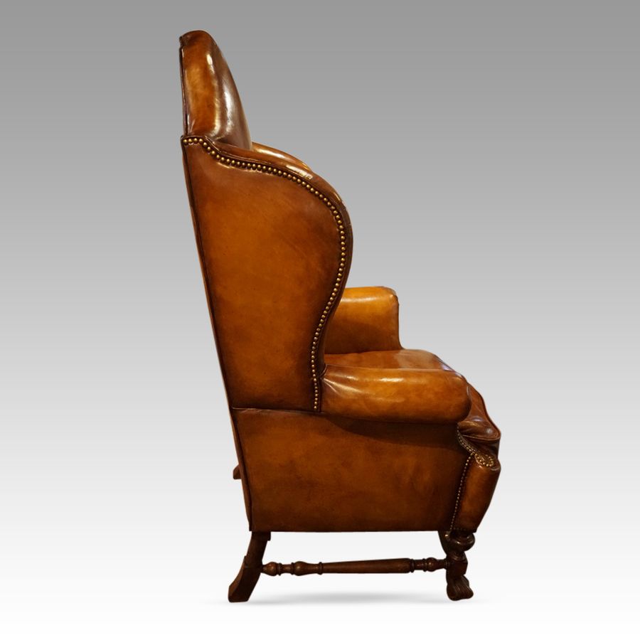 Antique Pair of large leather wing back chairs