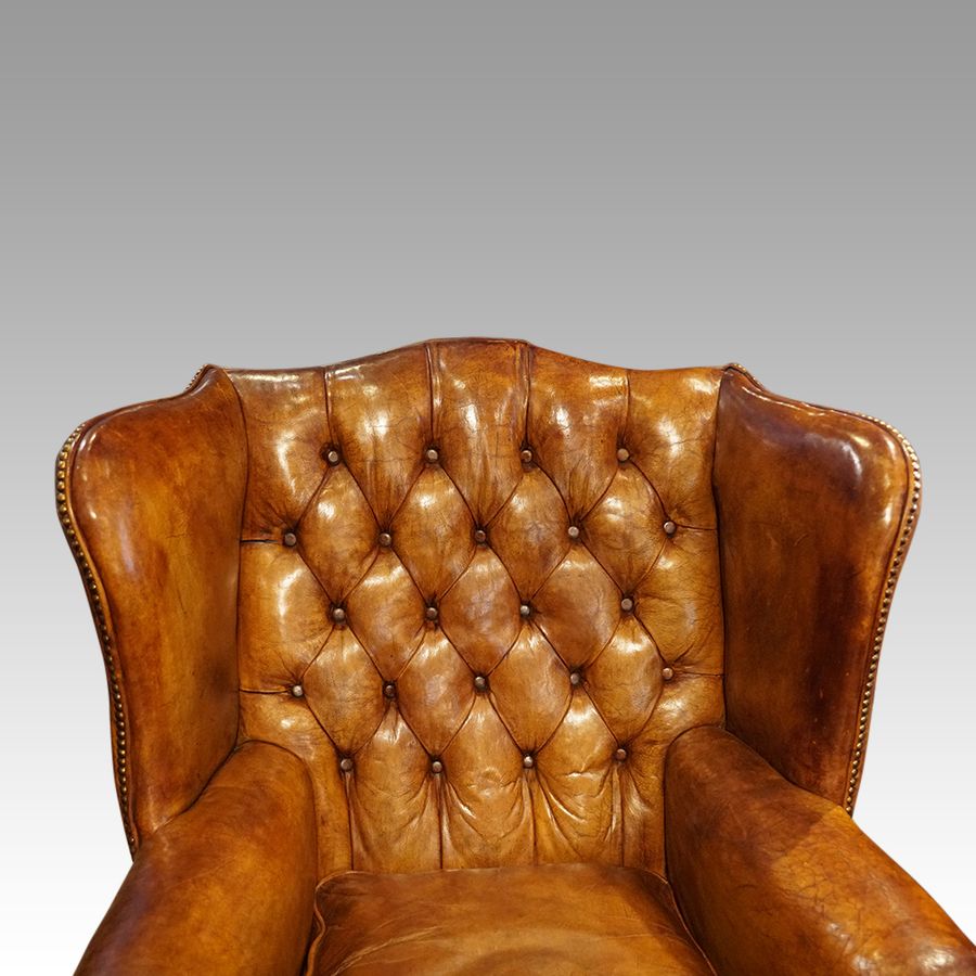 Antique George VI leather button back wingchair
