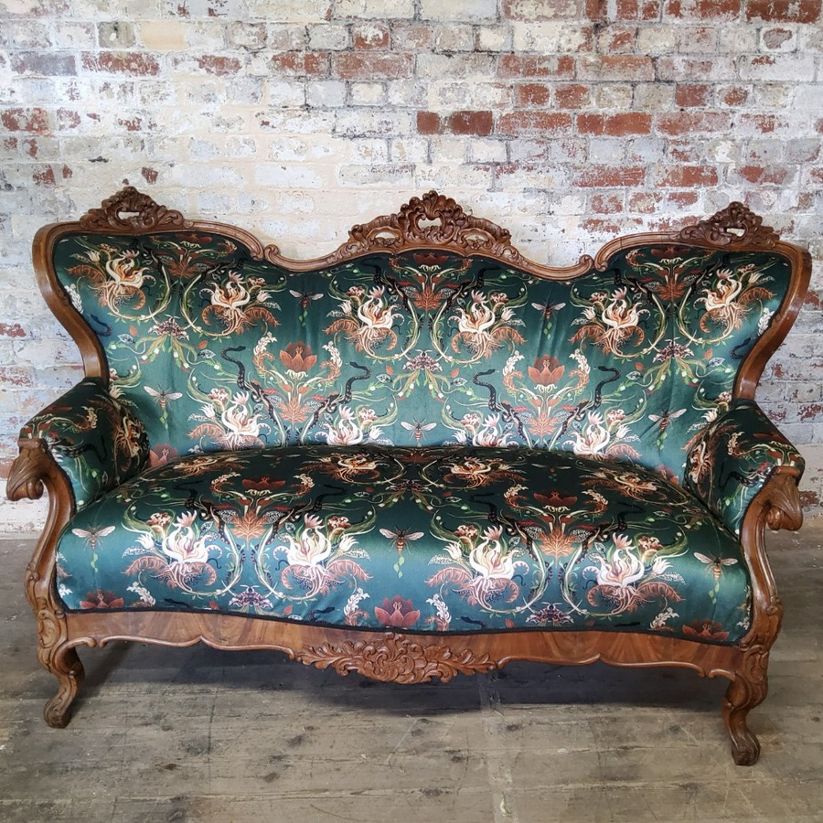 A 19th century French mahogany carved sofa re-upholstered in Becco Who fabric