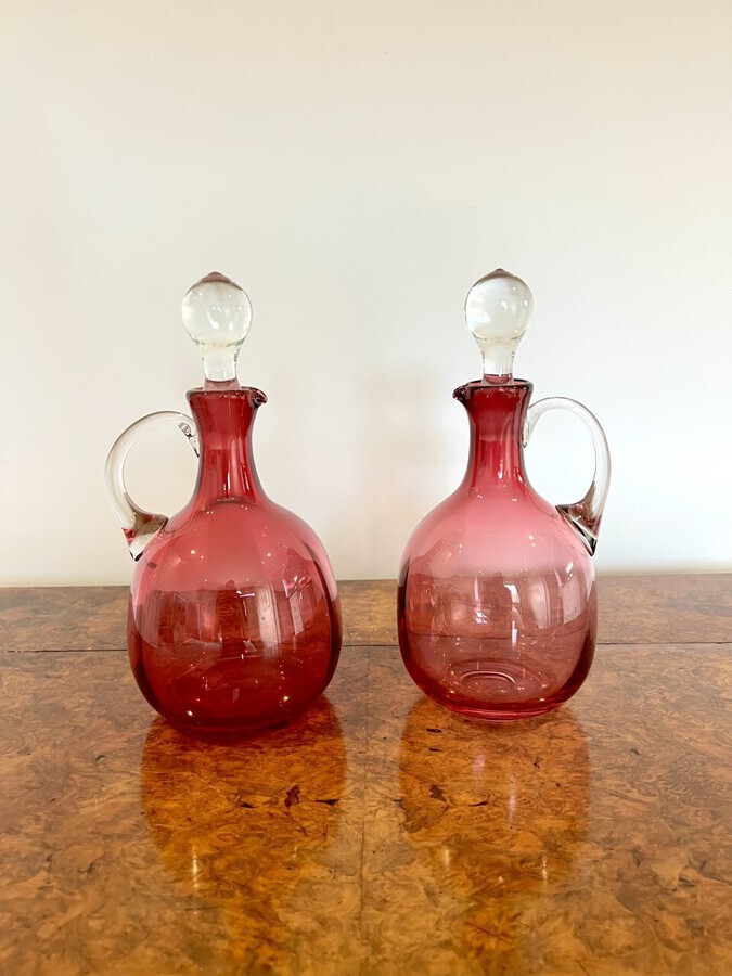 Antique Pair of quality Antique Victorian Cranberry Glass Decanters with twelve cranberry glass wine glasses
