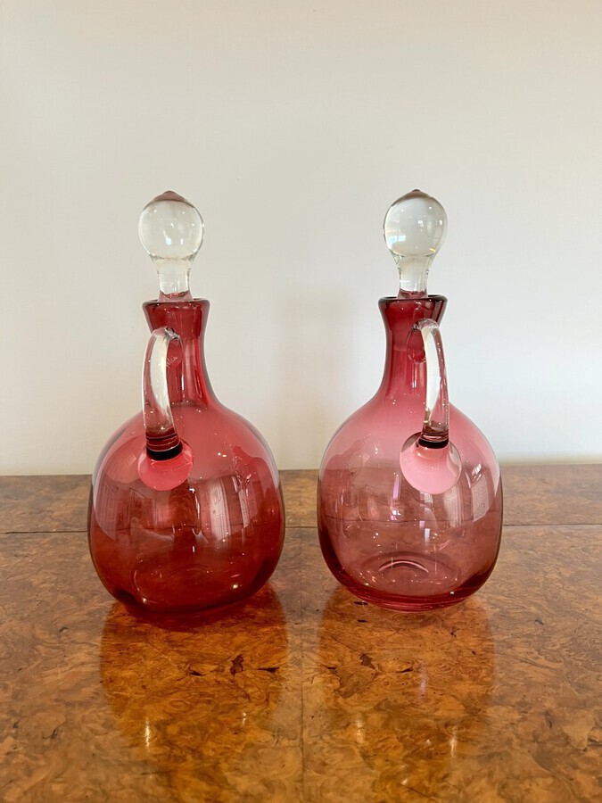 Antique Pair of quality Antique Victorian Cranberry Glass Decanters with twelve cranberry glass wine glasses