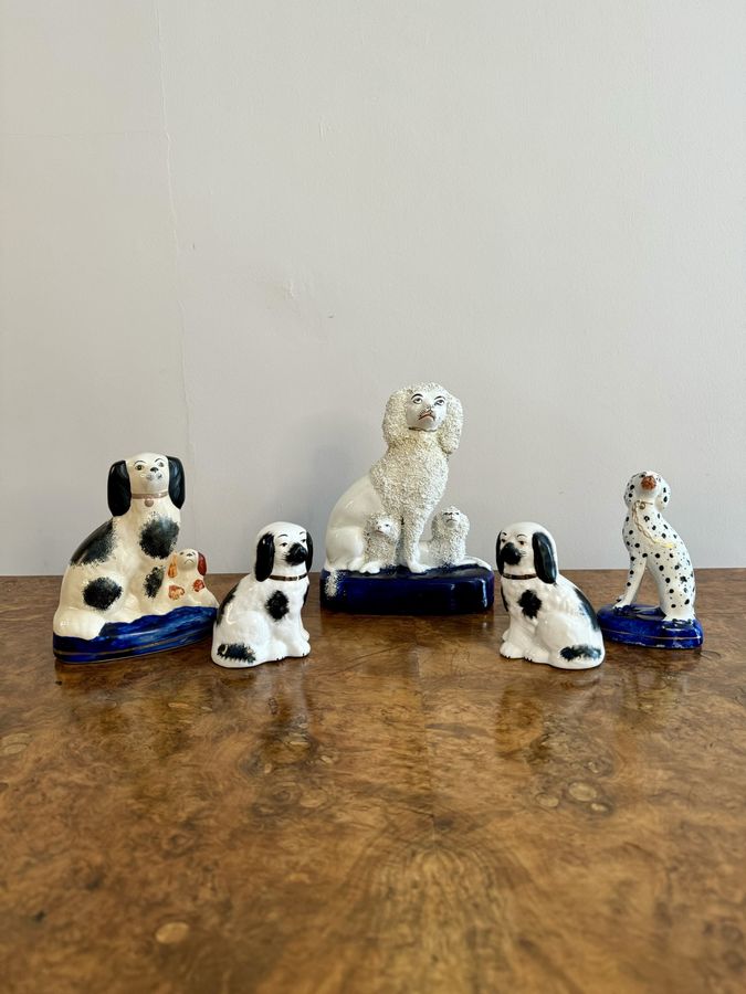 Unusual collection of five antique Staffordshire dogs