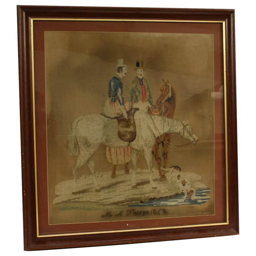 A 19th century Berlin woolwork picture, depicting a male and a female on horseback.