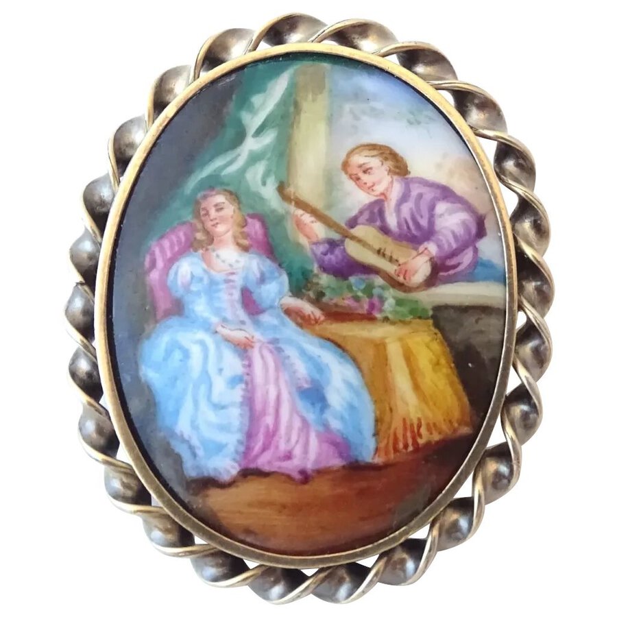 A 19th Century silver gilt brooch set with hand painted ceramic cabochon	
