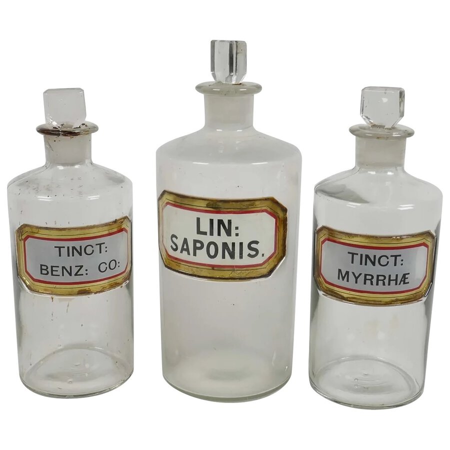 Antique Three antique chemist bottles and stoppers with enamelled labels	