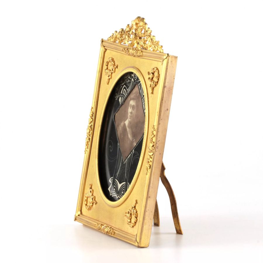 Antique Photo frame of gilded bronze in the style of neoclassicism.