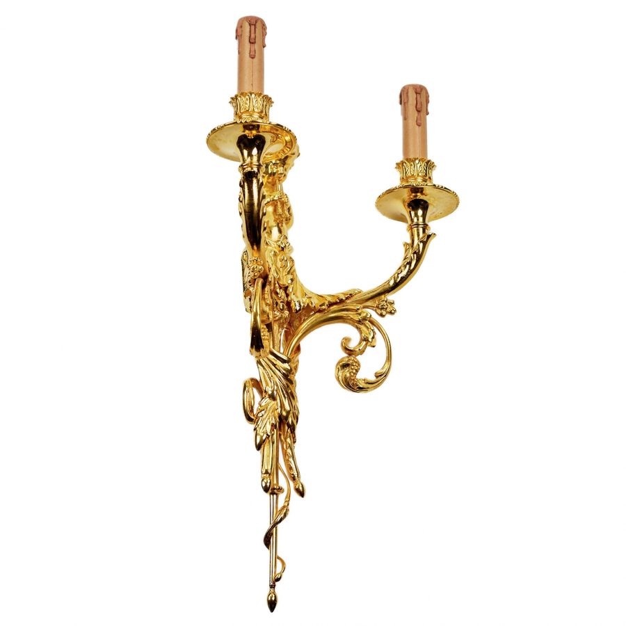 Antique A pair of gilded sconces, with currency curls, surmounted by cherubs.