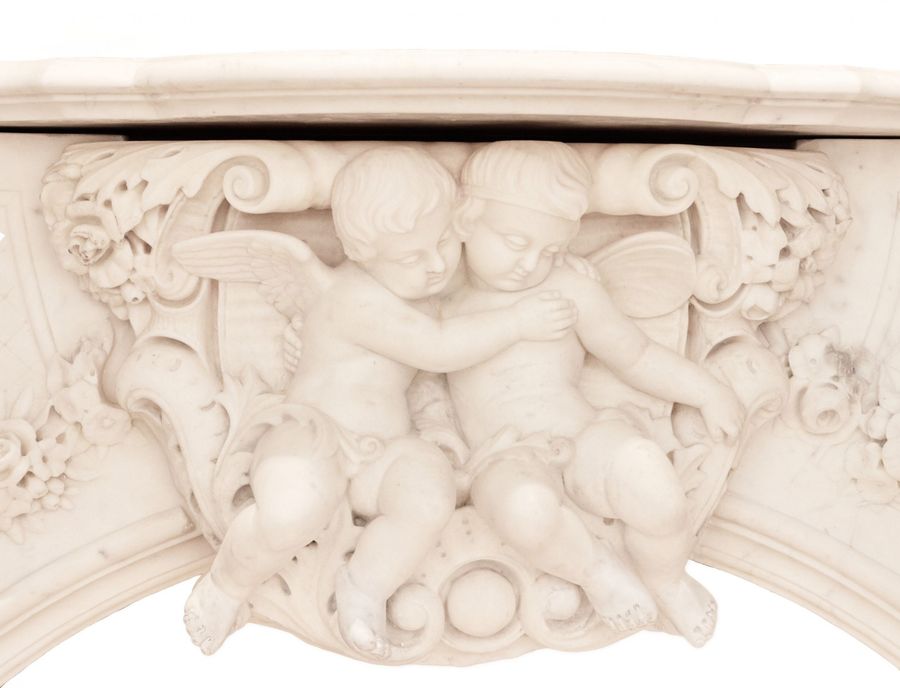 Antique French white marble fireplace with cupids, Louis XV style. 19th century
