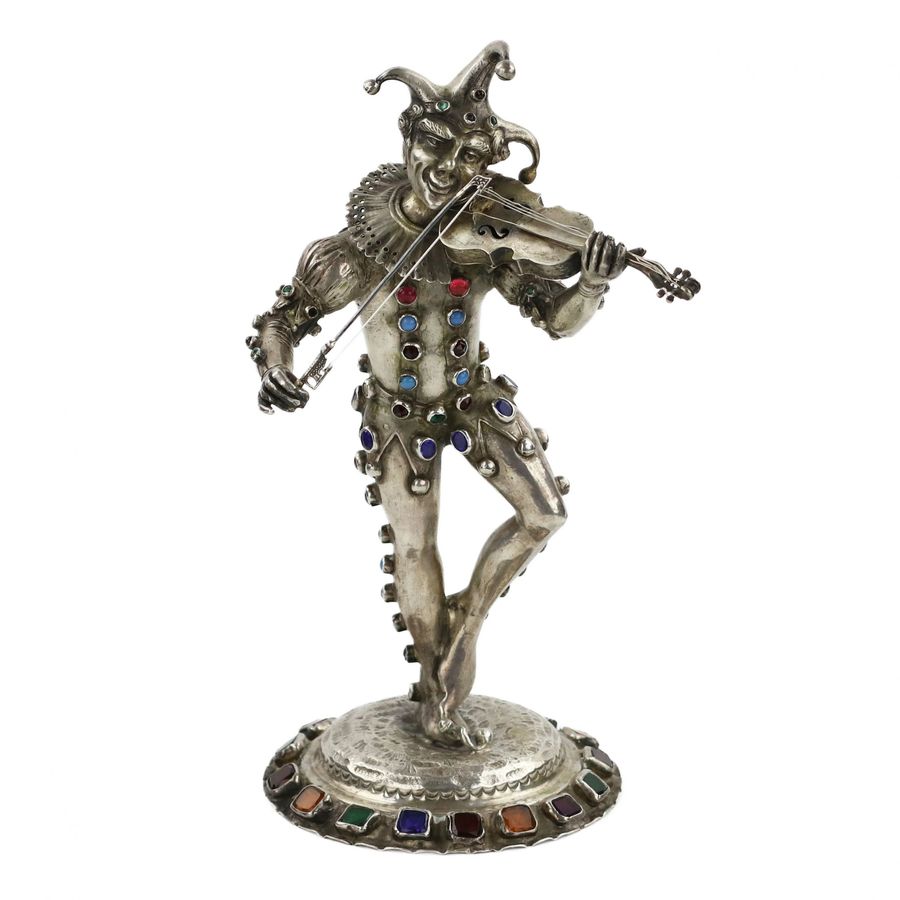 Silver figure of a playing Harlequin. Germany. 19th century.