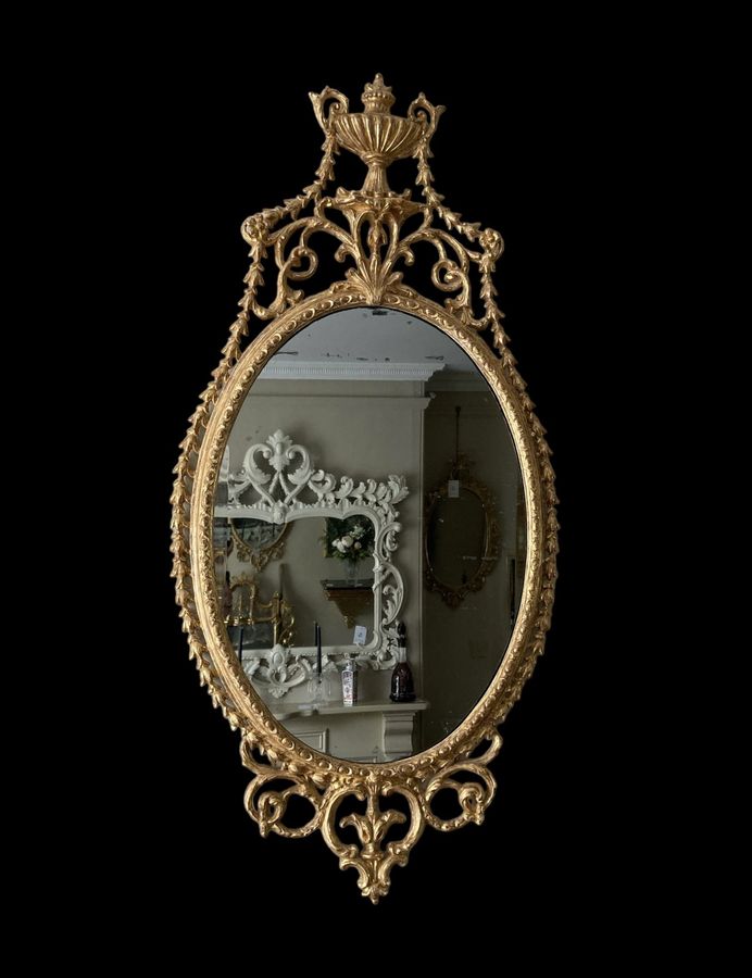 Antique An elegant George III giltwood and carton-pierre oval pier glass, late 18th Century
