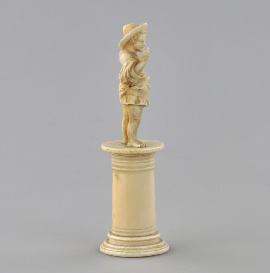 Antique Carved ivory figurine of a boy with a bird 1800s.