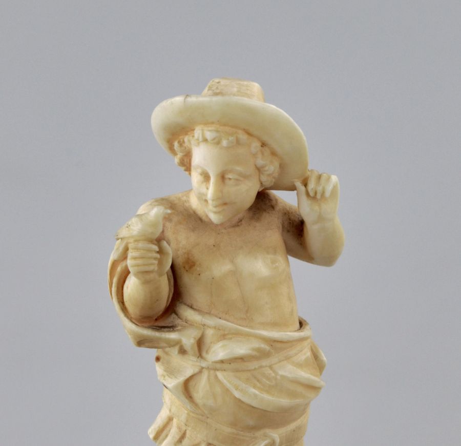 Antique Carved ivory figurine of a boy with a bird 1800s.