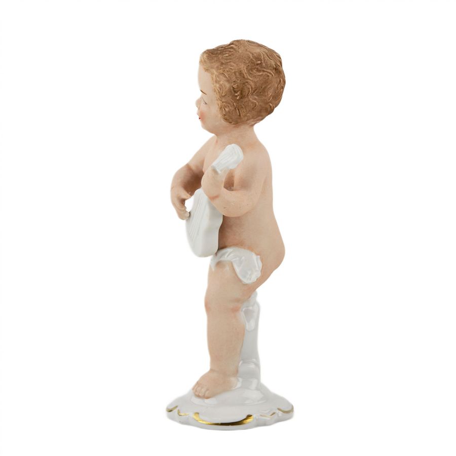 Antique Porcelain figurine of a putti playing guitar. Germany.