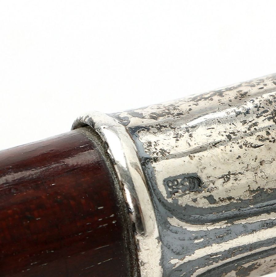 Antique Walking cane with a silver handle.