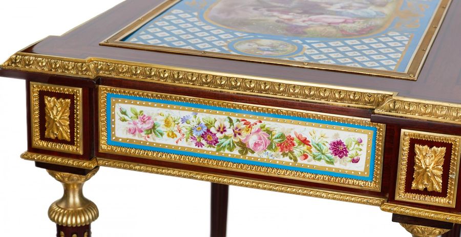 Antique A magnificent ladies table with gilded bronze decor and porcelain panels in the style of Adam Weisweiler. France. 19th century