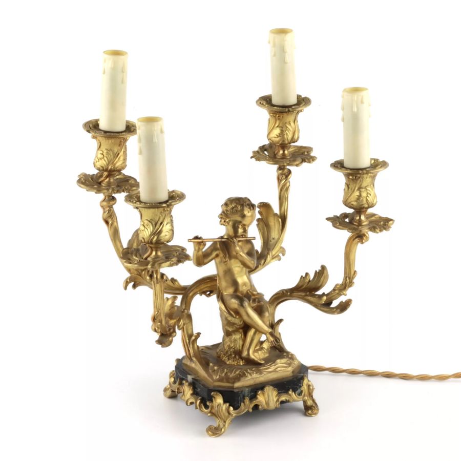 Antique Paired lamps of gilded bronze with cupids playing music.