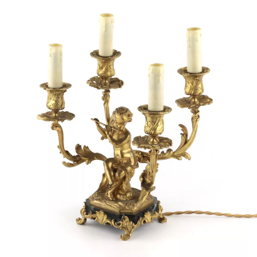 Antique Paired lamps of gilded bronze with cupids playing music.