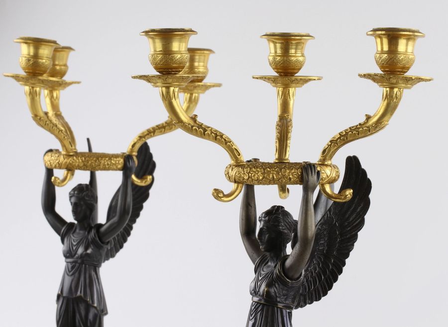 Antique A pair of bronze candlesticks in Empire style