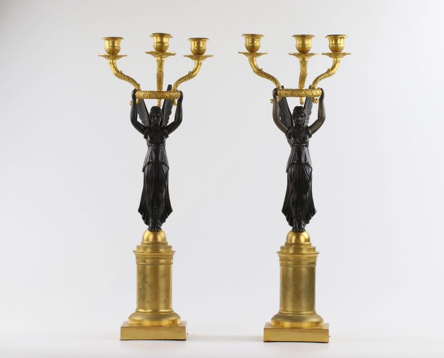 Antique A pair of bronze candlesticks in Empire style