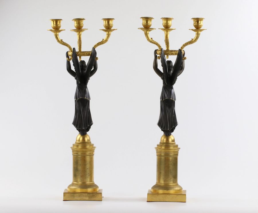 Antique A pair of bronze candlesticks in Empire style