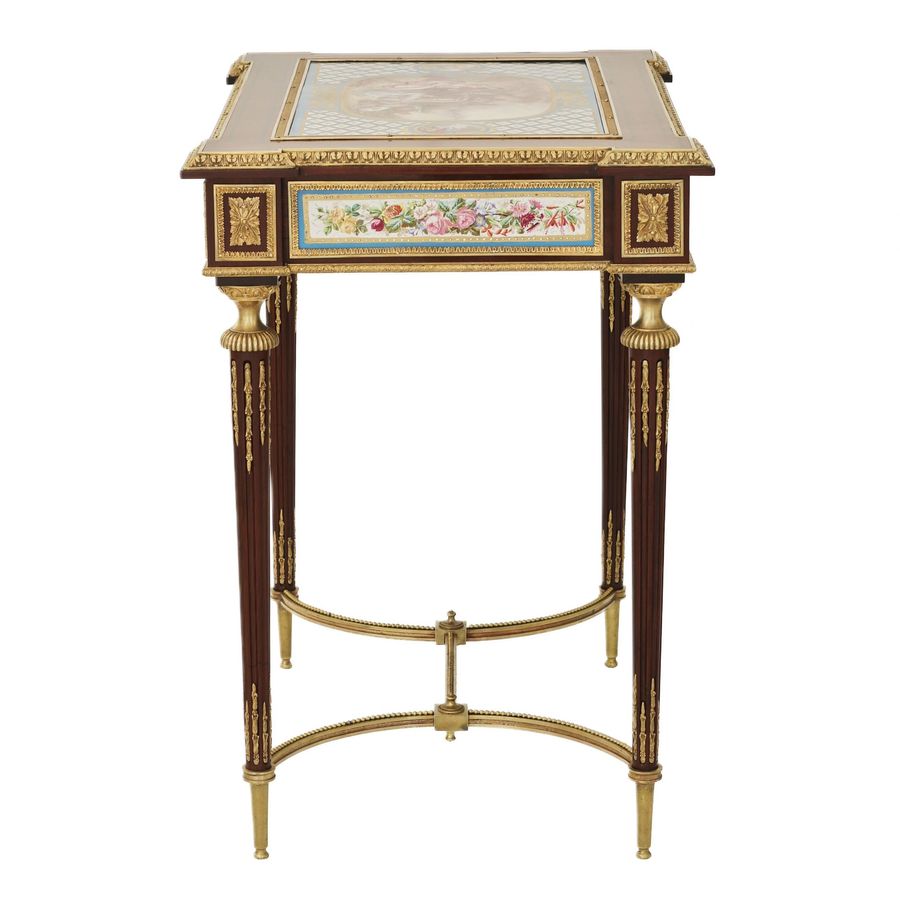 Antique A magnificent ladies table with gilded bronze decor and porcelain panels in the style of Adam Weisweiler. France. 19th century