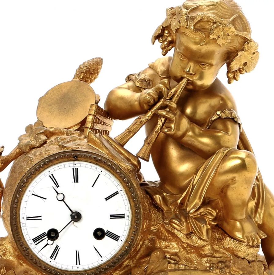 Antique Gilded bronze fireplace clock in the style of Louis XVI. France 19th century