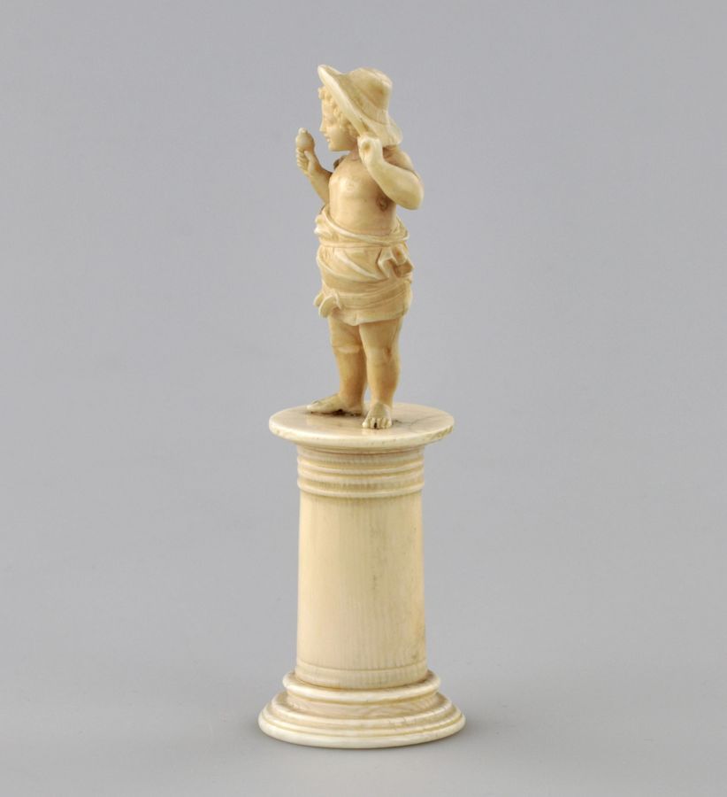 Antique Carved ivory figurine of a boy with a bird 1800s.