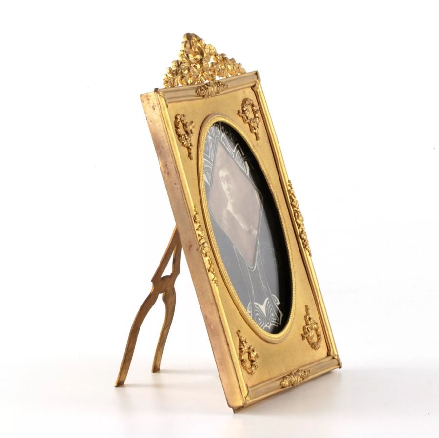 Antique Photo frame of gilded bronze in the style of neoclassicism.